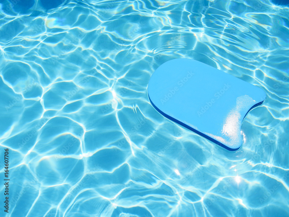 Wall mural Kick board floating in swimming pool.