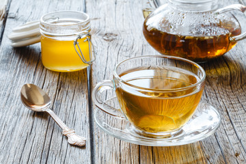 Brewed delicious herbal tea on a wooden black background