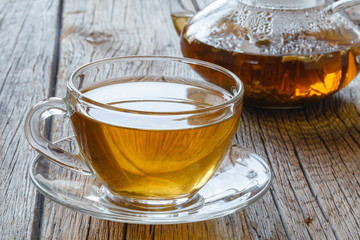 Herbal tea is scattered on gray vintage wooden board.