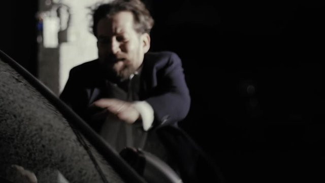 Female zombie attacking and killing man walking in garage slow motion