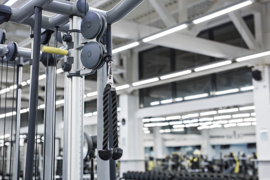 Closeup picture of hanging handle machine in a gym for pulling training.
