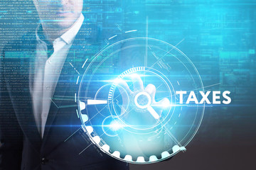 Fototapeta premium Business, Technology, Internet and network concept. Young businessman working on a virtual screen of the future and sees the inscription: Taxes