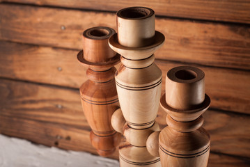 wooden candlestick. for the three candles. wooden background