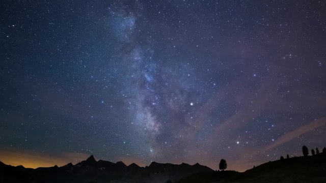 Time Lapse of the Milky way and the starry sky rotating over the majestic Italian French Alps in summertime, illuminated by the moonlight in the second half. Sliding version. 