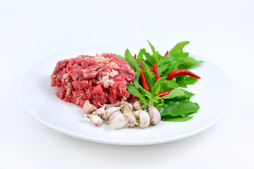 Ingredients of spicy fried meat with basil leaves.