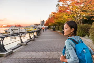 Fotobehang Vancouver city urban lifestyle people at Harbour, British Columbia. Woman tourist with student backpack in city outdoors enjoying autumn season. © Maridav