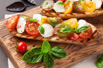 Bruschetta with tomatoes, mozzarella and basil