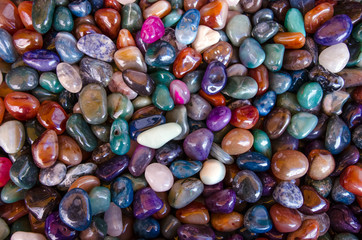 Happiness stones. Full frame colourful polished stones background. Close-up.