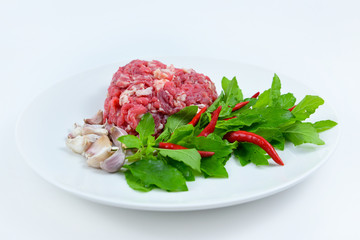 Ingredients of spicy fried meat with basil leaves.