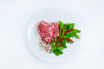 Ingredients of spicy fried meat with basil leaves.