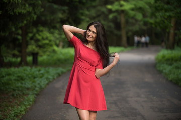 Attractive brunette woman wearing red short dress