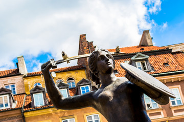 Sculpture of a mermaid in the old town in Warsaw on sunny day with blue cloudy sky. © HappyRichStudio