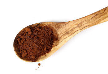 pile cocoa powder and wooden spoon isolated on white background