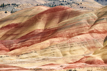 Surrealistic landscape of the slopes of Painted Hills in the John Day Fossil Beds National Monument. View from hiking trail.