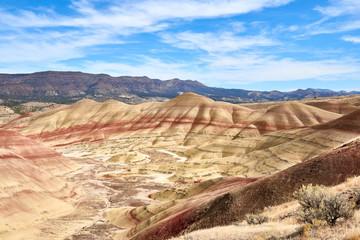 Surrealistic landscape of the slopes of Painted Hills in the John Day Fossil Beds National Monument. View from hiking trail.