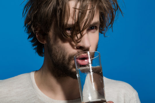 Man drink medicine drug with water from glass
