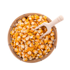 Corn seeds and wooden spoon isolated on a white background