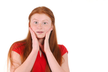 Fototapeta premium Red hair teenager girl in a red shirt showing a sincere surprise