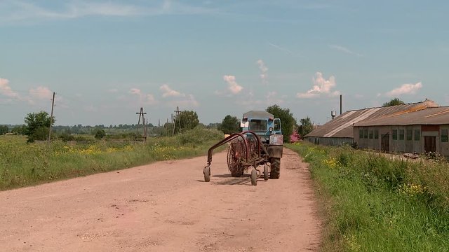 tractor driving on a country road in Russia