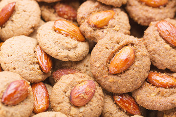 Crispy cookies with almond as a background close up. Selective focus