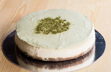 Whole cheesecake on a wooden table