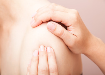 Woman receiving osteopathic treatment of her shoulder