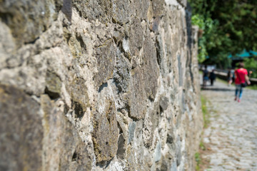 Old beige and gray wall with stone masonry with cracks, background, texture