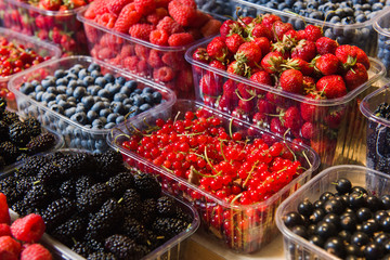 Fresh berries on display. Organic and fresh. Food background. Display on local farmers market.