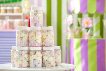 Tasty marshmallow in jars at candy shop