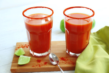 Delicious cocktails with tequila on wooden board
