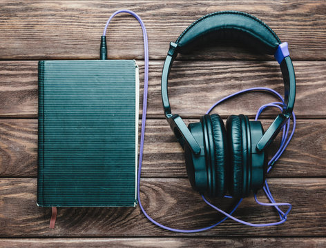 Headphones with a book.