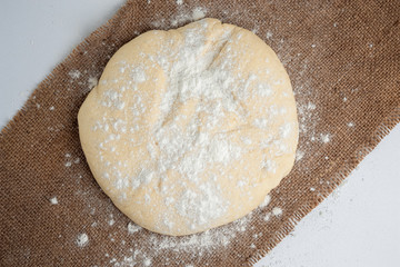 Ball of dough for pizza on the background of rustic