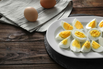Plate with hard boiled eggs on table. Nutrition concept