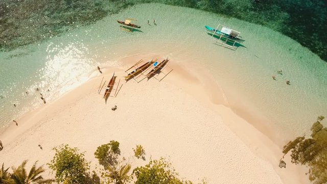 Aerial view of beautiful tropical island Guyam with white sand beach. View of a nice tropical beach from the air. Seascape: Ocean and beautiful beach paradise. Philippines. 4K video. Travel concept
