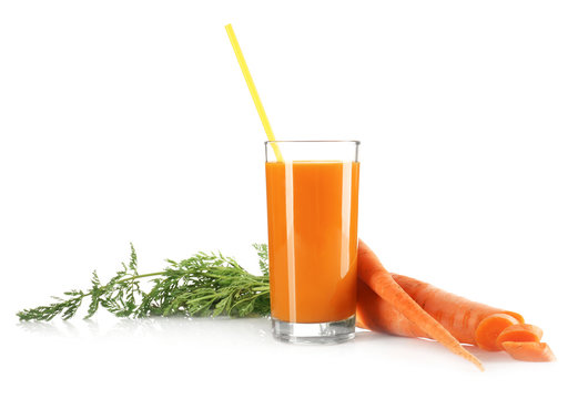 Glass of juice and fresh carrots isolated on white