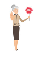 Caucasian business woman holding stop road sign.