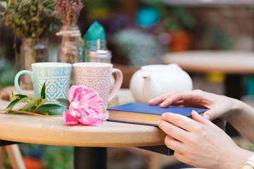 woman in a restaurant reading a book