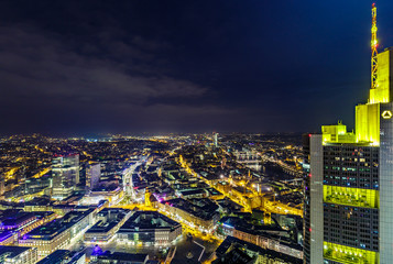 Fototapeta premium Skyline of Frankfurt, the financial capital of Germany, at night with crescent moon. HDR photograph taken from the top of Main Tower.