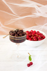 Glass with homemade Cherry Jam on wooden background