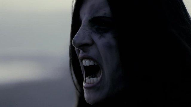 Woman zombie screaming in pain slow motion