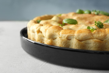 Baking dish with turkey pot pie on table, closeup