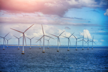 Shot of row of floating wind turbines - 164631532