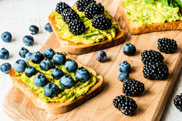 sandwiches with avocado and berries. healthy vegetarian food