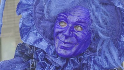 Close-up portrait of a person in a blue mask. Woman with typical beautiful blue mask from traditional carnival. Venice mask portrait. Kaliningrad - July 2017 Russian.