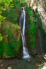 Beatyful waterfall sorrounded with green vegetation. Fraga da Pena. Portugal.