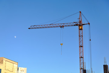 Construction crane against the blue sky