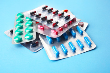 Different pills on color background