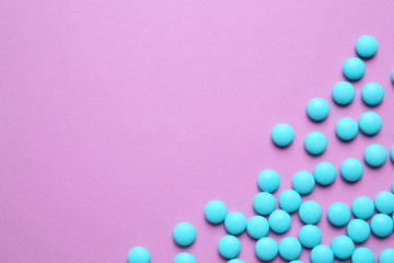 Blue pills on color background
