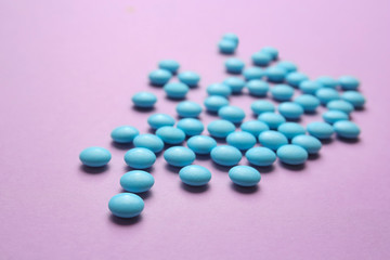 Blue pills on color background