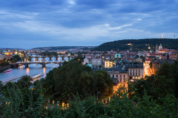 Fototapeta na wymiar Bridges over Vltava River and buildings at the Mala Strana District (Lesser Town) in Prague, Czech Republic, viewed slightly from above in the evening.